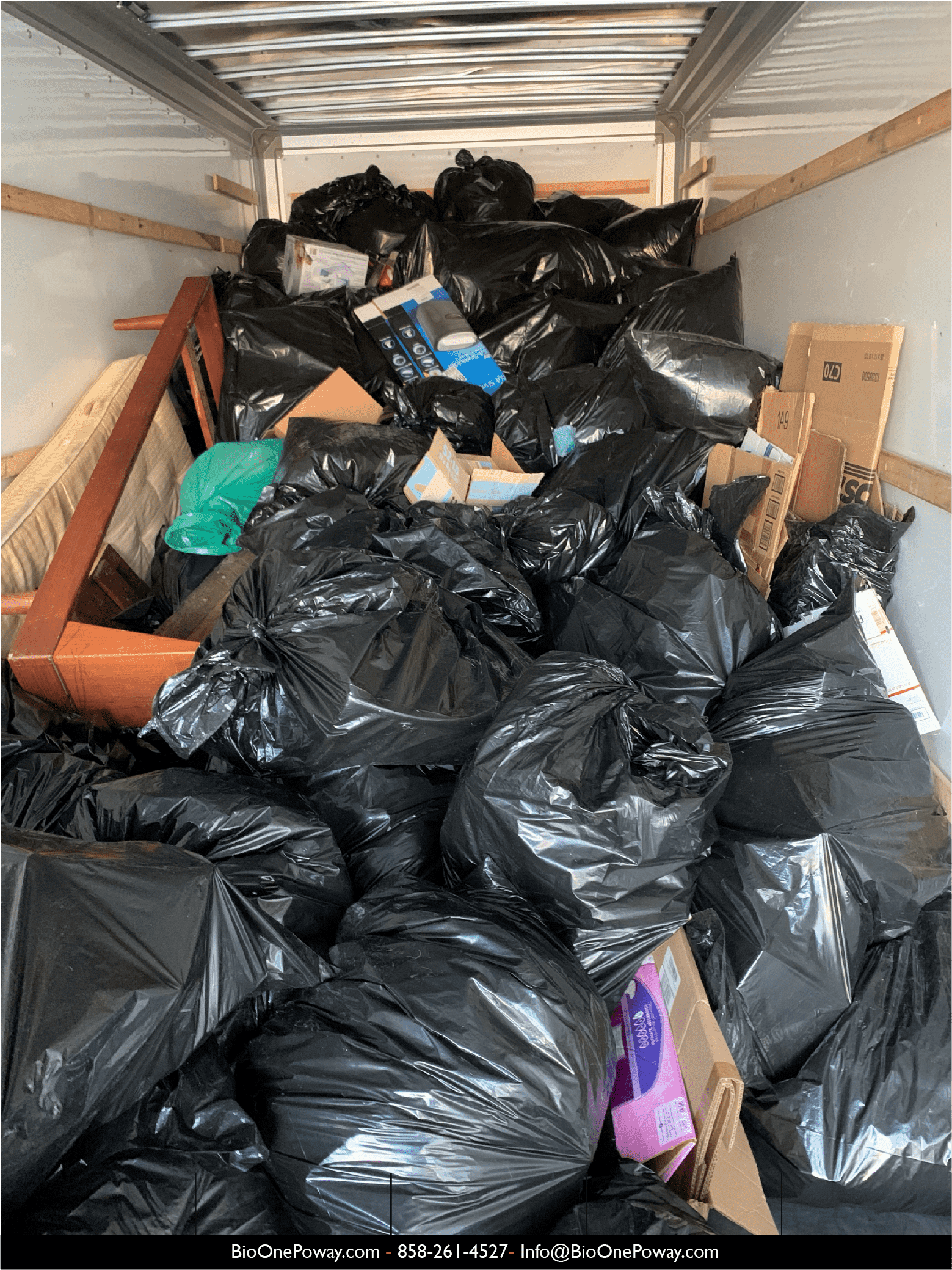 Image shows bags of trash, furniture, cartonboard, and other debris removed by Bio-One technicians from a hoarded property.